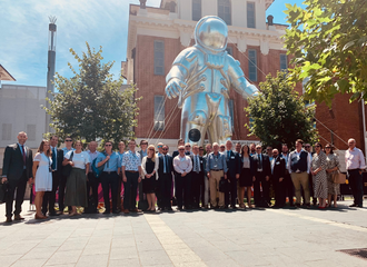 Image of UK Space Trade Delegation standing infront of giant silver astronaut figure at Lot Fourteen in Adelaide