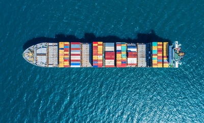 Cargo ship with colourful cargo containers on board at sea